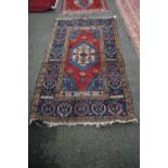 A Turkish rug, with central medallion on red field, 175 x 100cm.