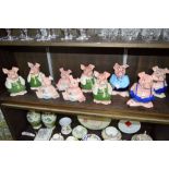 Ten various Wade 'Nat West' piggy banks.