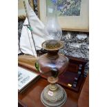 An Art Nouveau brass and coloured glass oil lamp; together with another brass oil lamp.