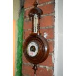 A walnut aneroid barometer.