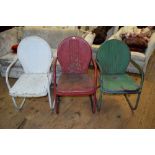 Three vintage painted metal lawn chairs, possibly American.