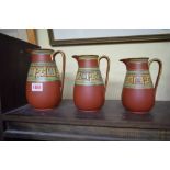 A graduated set of three Victorian Prattware jugs, largest 18.5cm high.