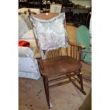 An early 20th century beechwood stickback rocking chair.