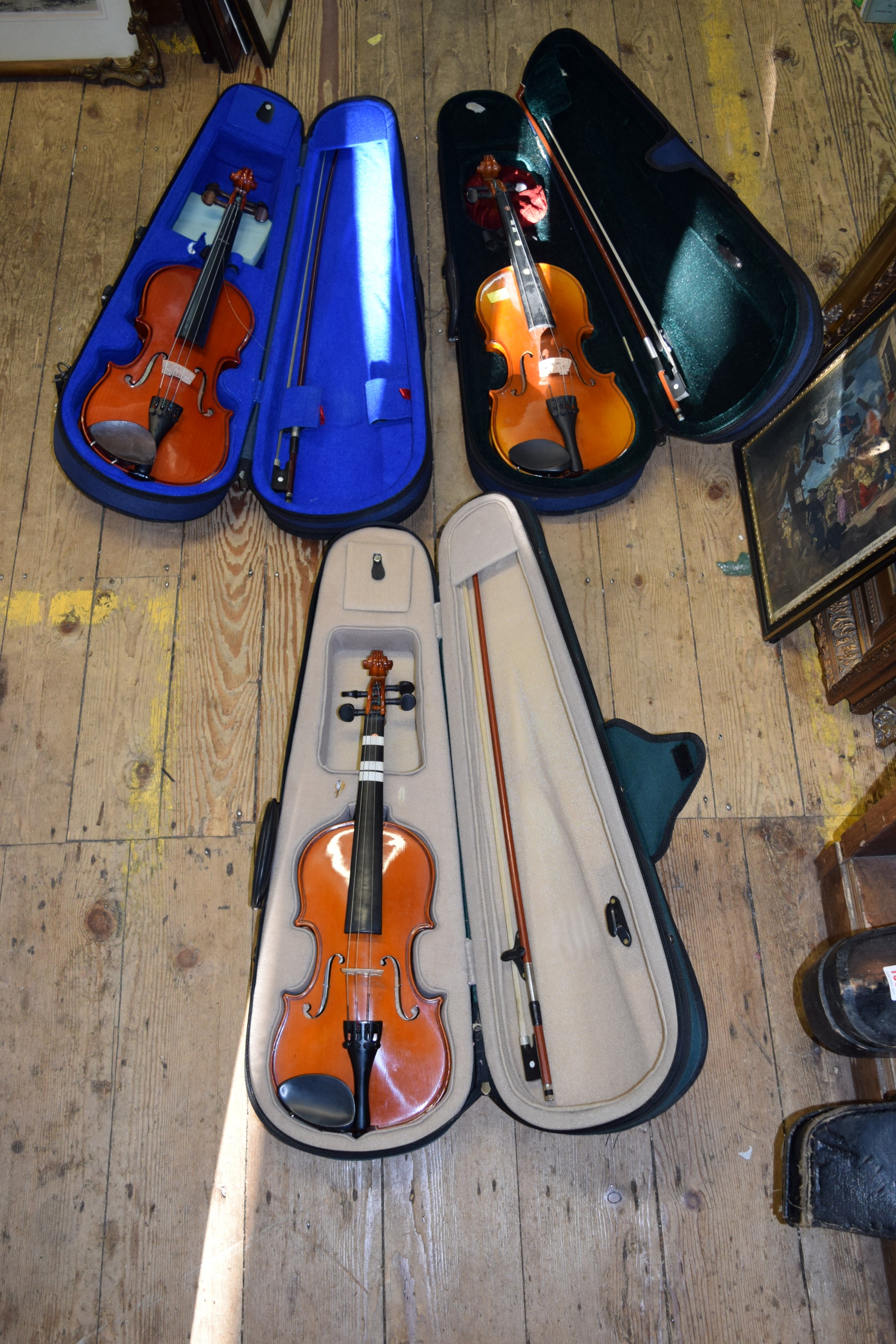Three various children's violins, two with 12 inch backs and one with 12½ inch back,