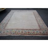 An unusual Kerman style carpet, plain filled centre with corner decoration and large floral border,