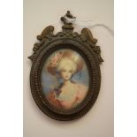 A portrait miniature of an elegant lady, 6.6 x 5.4cm, oval, in a cast brass frame.