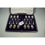 A cased set of twelve silver teaspoons and sugar tongs, by Josiah Williams & Co, London 1921, 143g.