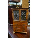 An old 18th century style walnut miniature bookcase on chest, 36.5cm high.