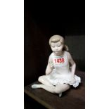 A Nao figure of a seated ballerina.