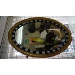 An old Irish style gilt gesso and coloured bead frame oval wall mirror, 72 x 52cm.