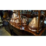 A matched graduated set of seven copper haystack measures, largest 4 gallon.