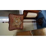 An early Victorian rosewood and needlework pole screen.