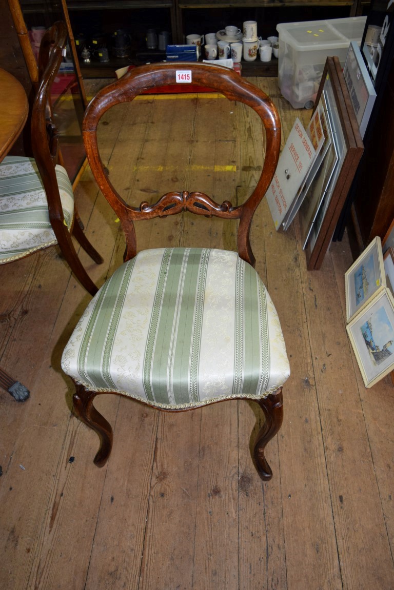 A set of six Victorian walnut balloon back dining chairs, on moulded cabriole legs.