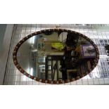 An Irish style coloured bead framed oval wall mirror, 78 x 52.5cm.