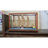 A cased water line model of a 19th century clipper, the whole 38cm wide.