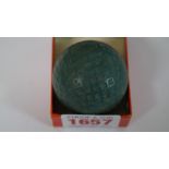 A scarce vintage green golf ball, probably a Dunlop Warwick, with square dimples,