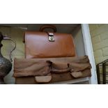 An old tan leather suitcase, with canvas outer; together with another tan leather briefcase.