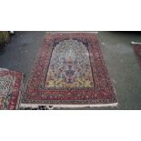 A pair of Persian Isfahan prayer rugs, having light blue floral field with large vases, trees,