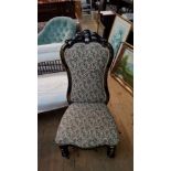 A Victorian papier-mache and upholstered nursing chair.