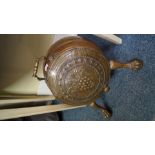 An unusual 19th century patinated brass coal scuttle, of barrel form with paw feet.