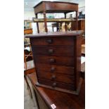 A stained wood miniature chest of drawers, 35.5cm wide.