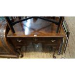 An 18th century walnut, feather and crossbanded lowboy,