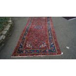 A Persian Hamadan Kelleh narrow carpet, with allover Herati field and central medallion,