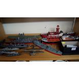 A collection of polychrome painted naval ship models and other vessels; together with a bi-plane.