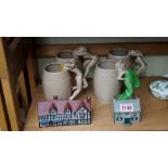 A set of four Japanese pottery risque mugs; together with a Goss model of 'The Cat & Fiddle Inn';