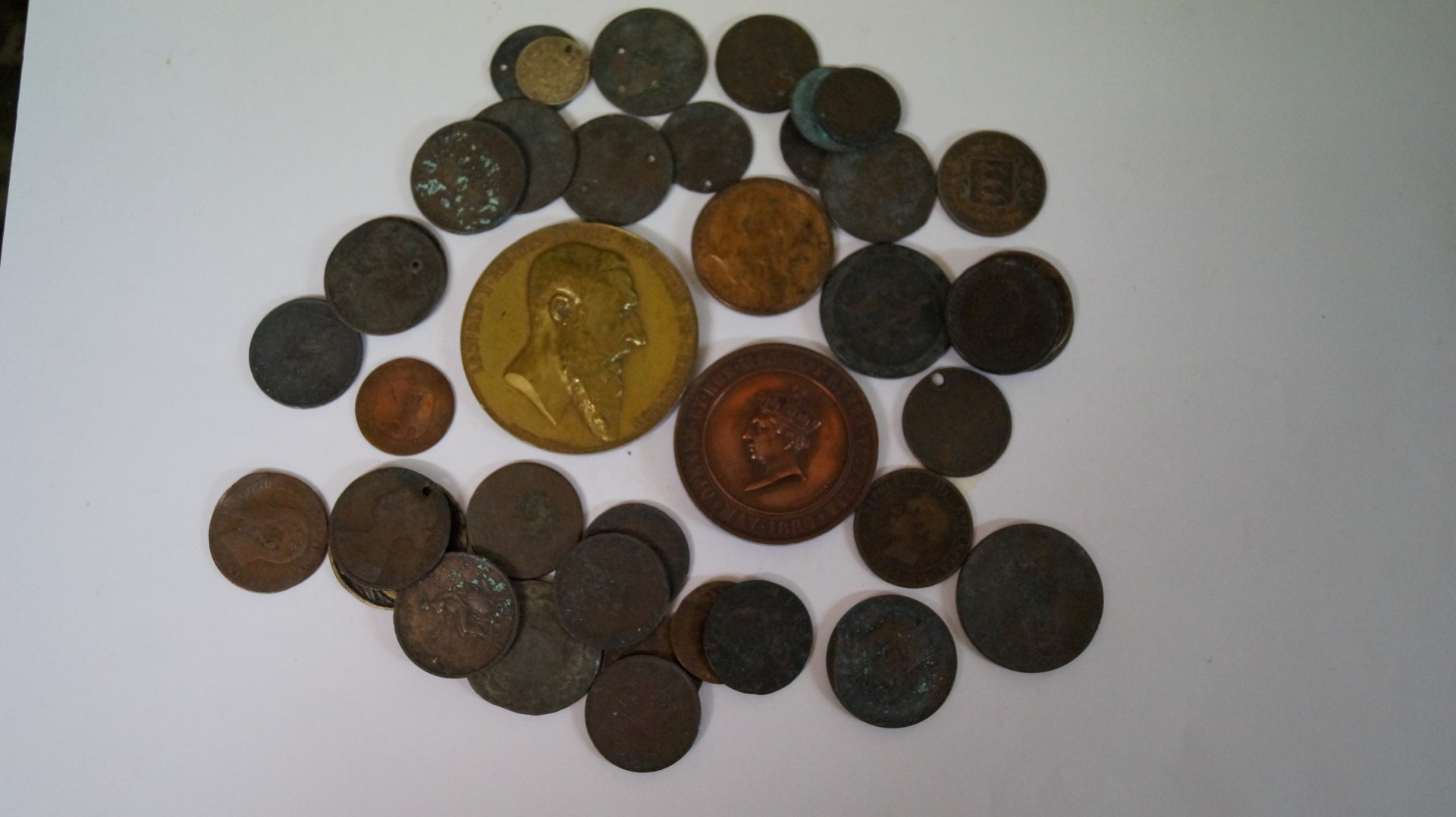 A small quantity of coins and tokens; together with a Victorian 1886 Liverpool Exhibition medal.