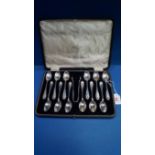 A cased set of twelve silver teaspoons and tongs, by Walker & Hall, Sheffield 1917, 302g.