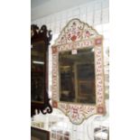 An antique wall mirror, with red decorated frame, 66cm high.