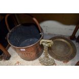 A Persian copper swing handled bucket; together with a Cairo ware charger; and a brass doorstop.