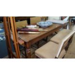 A 19th century pitch pine farmhouse table, with three plank top and turned tapering legs,