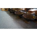 A set of four Victorian black painted cast iron oval pedestal planters,