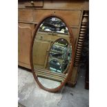 An Edwardian mahogany and chequer strung oval wall mirror, 91 x 53cm.