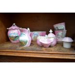 A large collection of Continental pink lustre souvenir ware, to include a fairing.