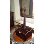 A Georgian style mahogany bottle stand, with pine cone finial, 46cm high.