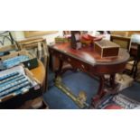 A circa 1840 carved mahogany library table, on trestle ends with paw feet, 136cm wide.