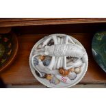 An Italian circular pottery dish with Palissey style cover, encrusted with a crayfish and shells,