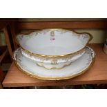 A French porcelain tureen and stand by Jules Etienne, the stand 34cm wide.