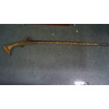 An antique Arab musket, with studded metal and bone decoration.