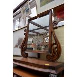 An unusual William IV mahogany toilet mirror, with anthemion supports, 65.5cm wide.