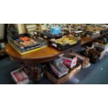 A late Victorian oak extending dining table, to include five associated leaves,