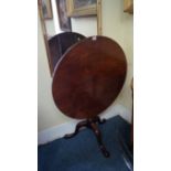 A George III mahogany circular tilt-top tripod table,