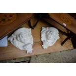 A pair of plaster mask wall brackets, 30cm wide.