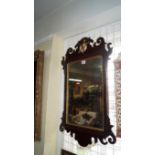 An 18th century mahogany and parcel gilt fret framed wall mirror, 76cm high.