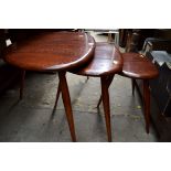 A nest of three Ercol 'Pebble' tables, 64.5cm wide.