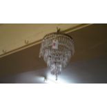 An old faceted glass drop four tier bag chandelier, 25cm diameter.