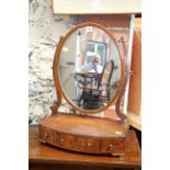 A 19th century mahogany bow front toilet mirror, 43cm wide.